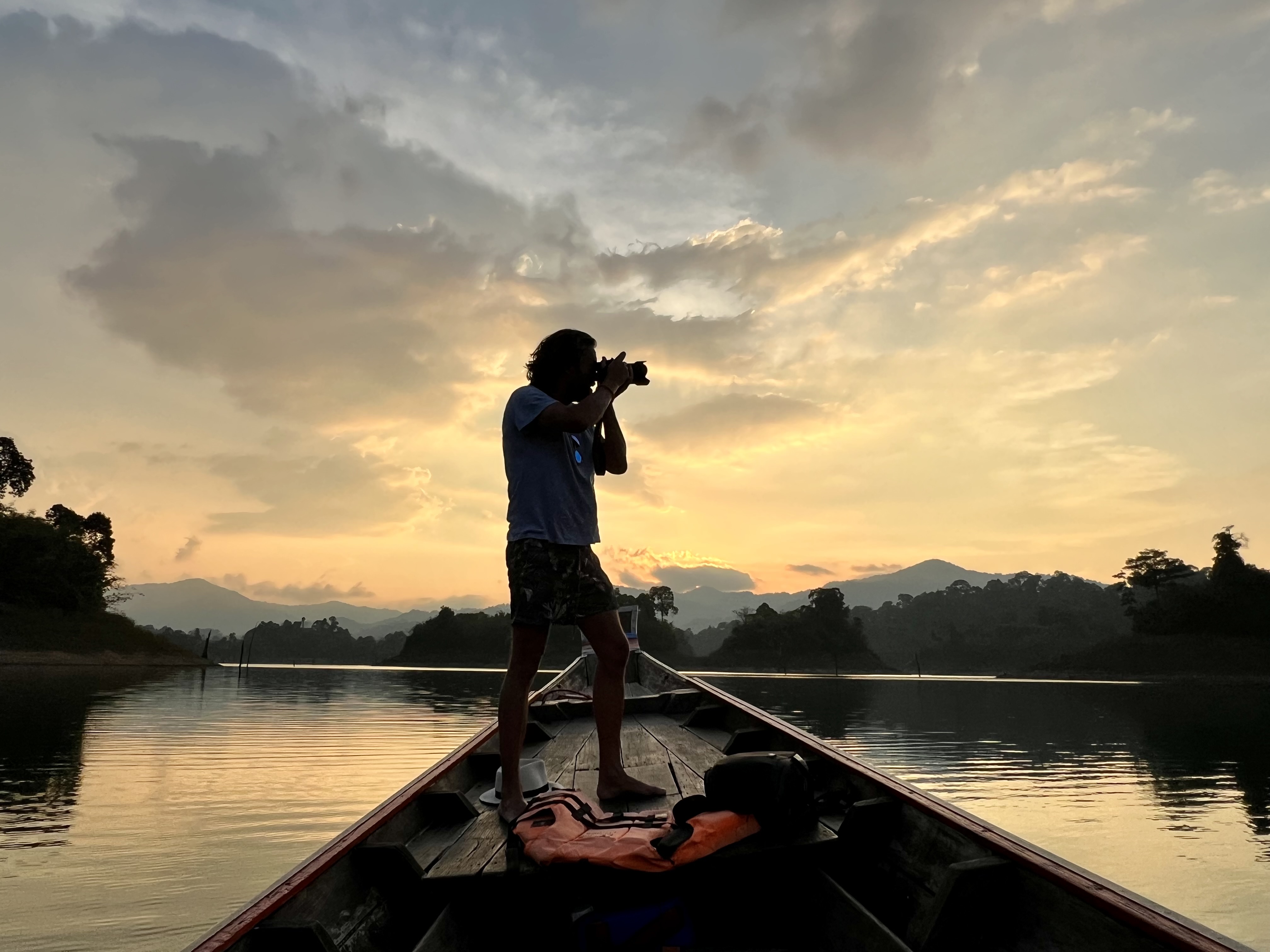 Loek van Doorn photographing at sunset on a longtail boat, Khao Sok Thailand